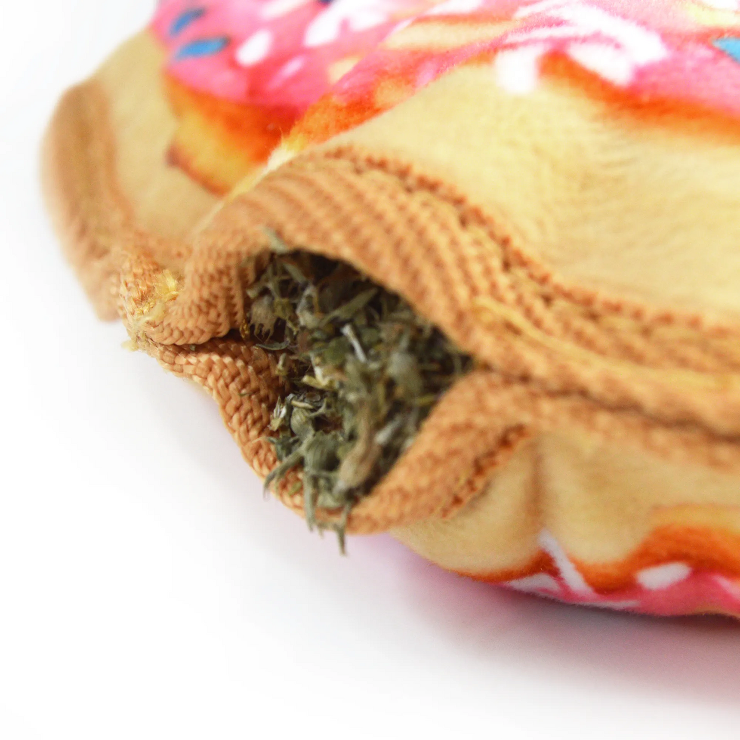 Close-up of Juananip-filled donut toy with dog-friendly catnip, perfect for interactive play that promotes relaxation and longer chew time.