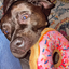 Dog enjoying a donut-shaped toy, holding it in its mouth with a joyful expression, featuring calming Juananip for a relaxing play session.